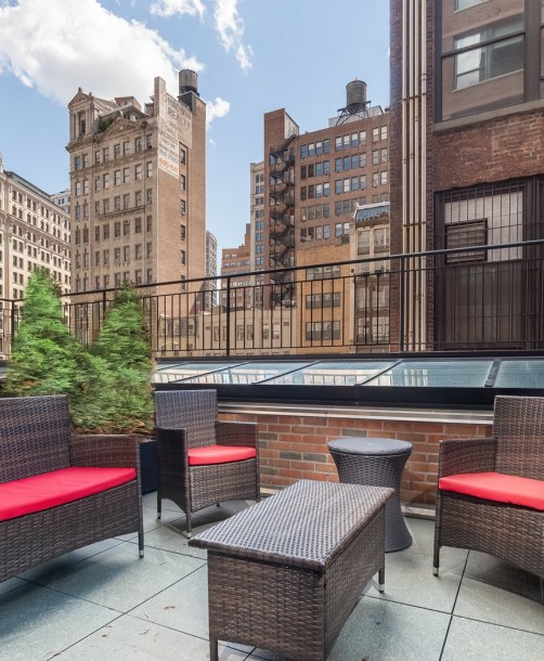 outdoor terrace with red cushioned patio furniture